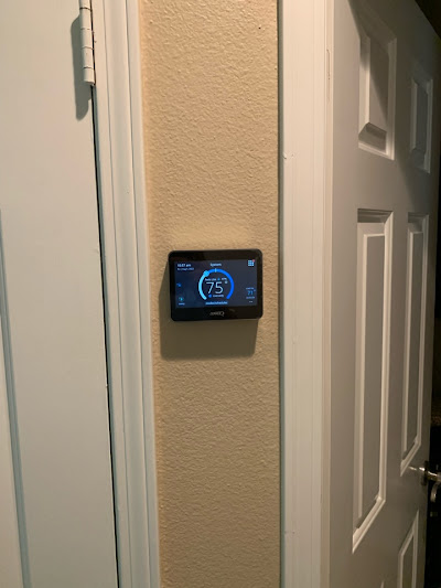 Wall-mounted smart thermostat with a digital interface