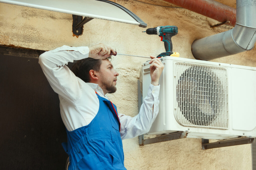 A professional technician installing an new heat pump