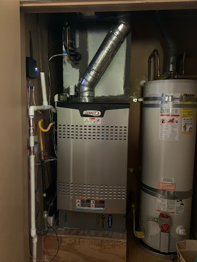 Gas furnace and water heater positioned in a small utility room